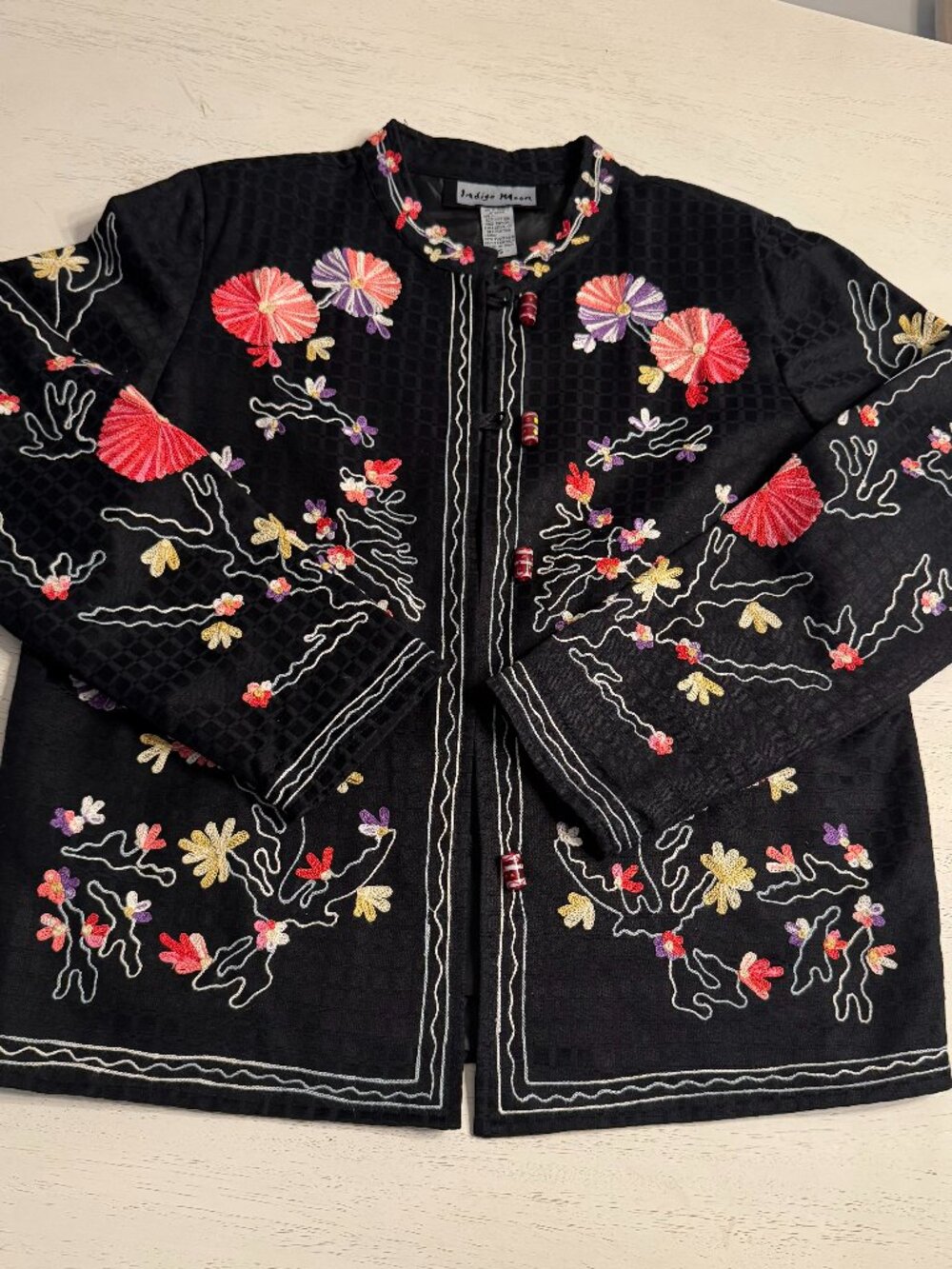 Vintage Indigo Moon jacket with embroidered floral pattern on black background